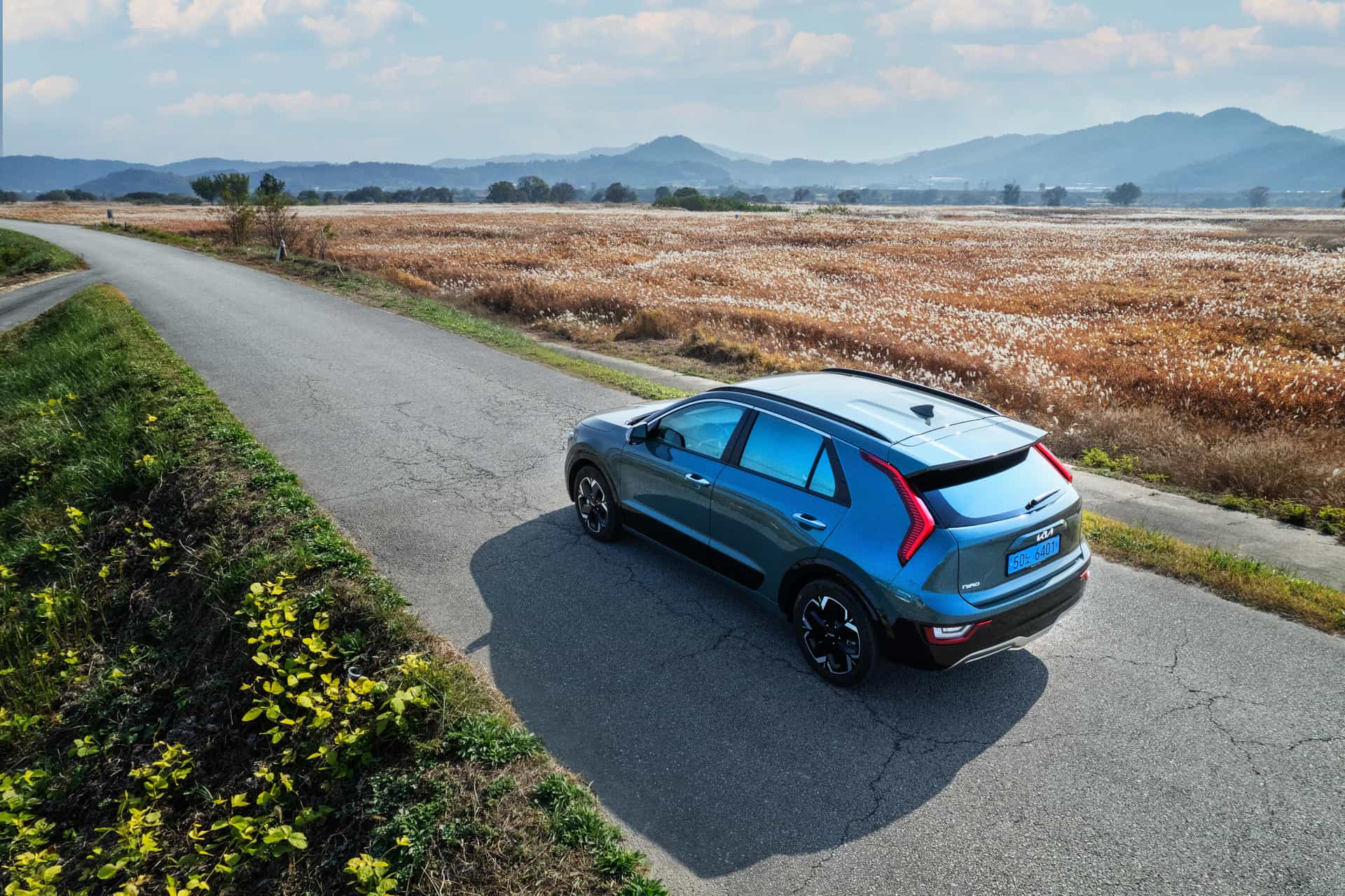 A blue compact crossover on a country road