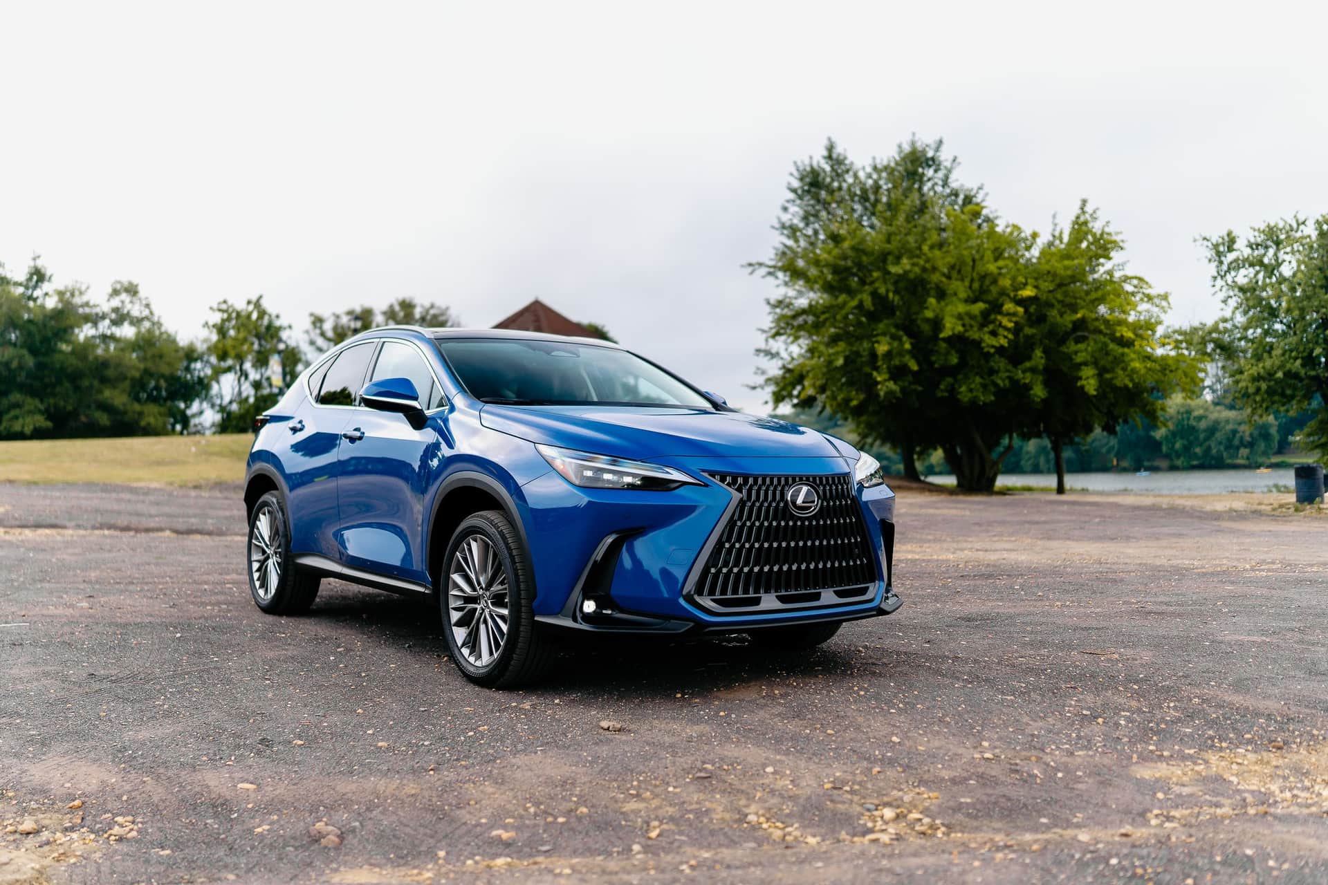 A blue Lexus SUV parked on gravel