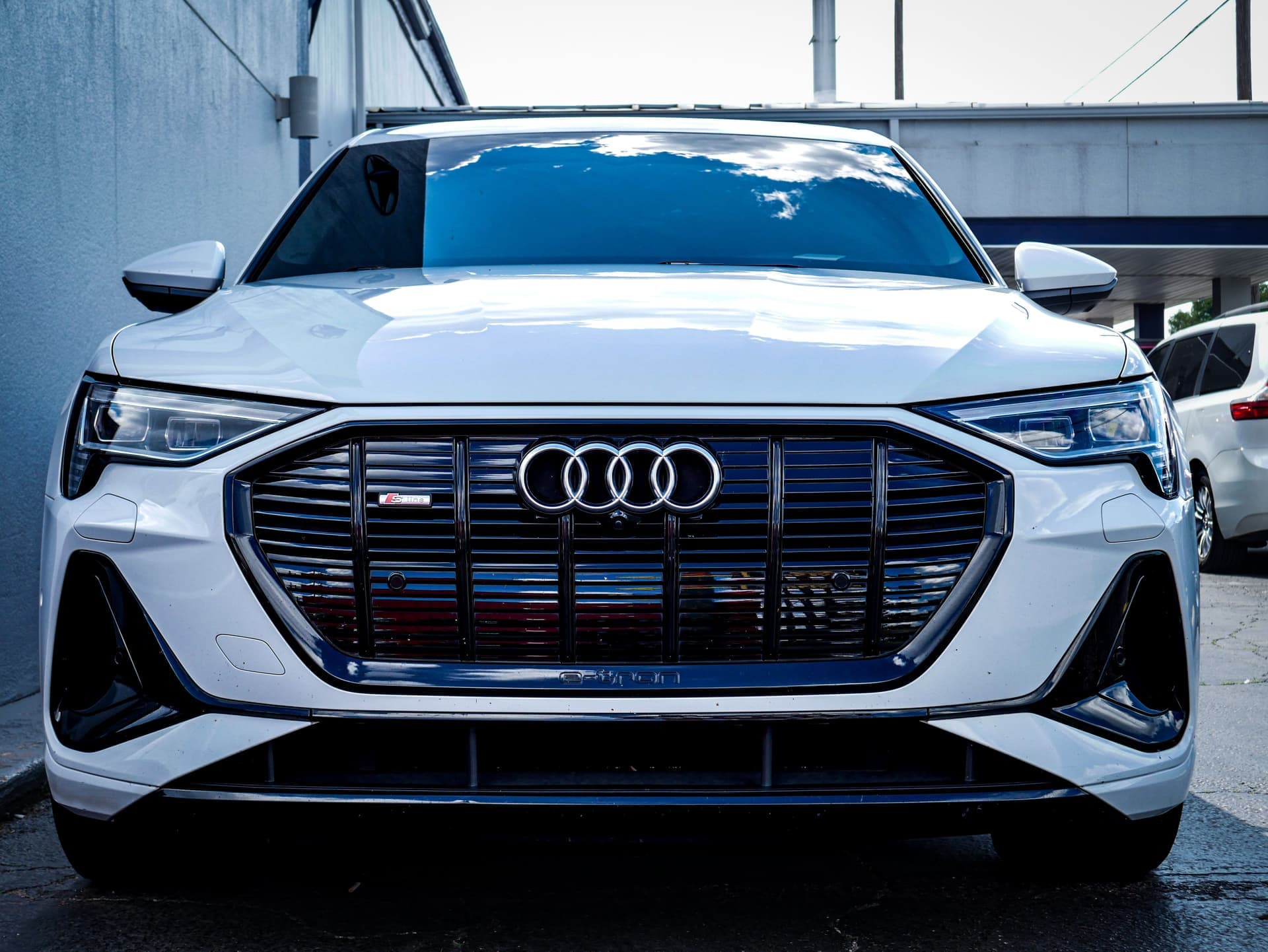 A white Audi e-tron SUV seen from the front