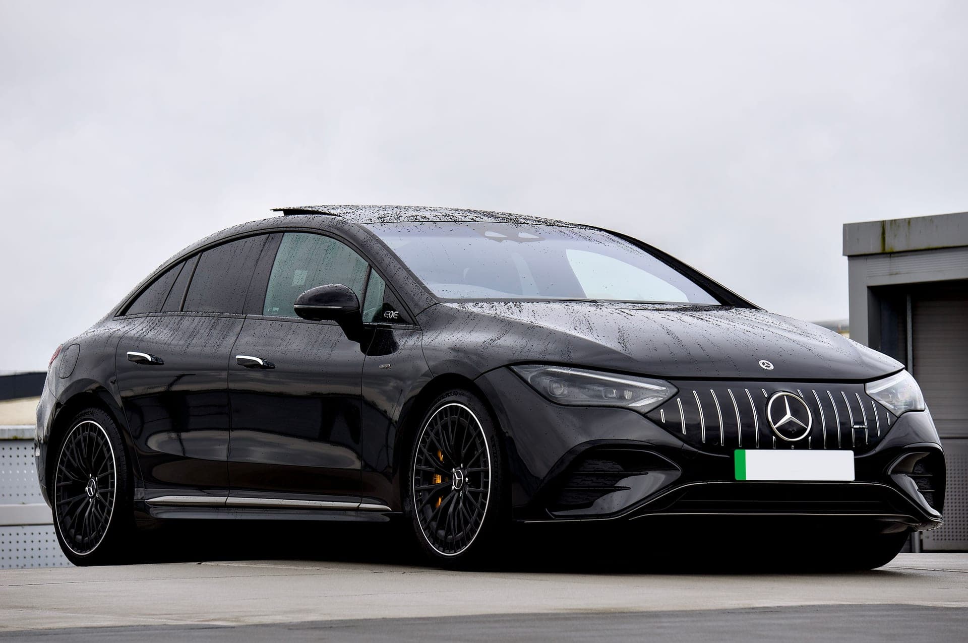 A black Mercedes-Benz electric sedan parked outdoors