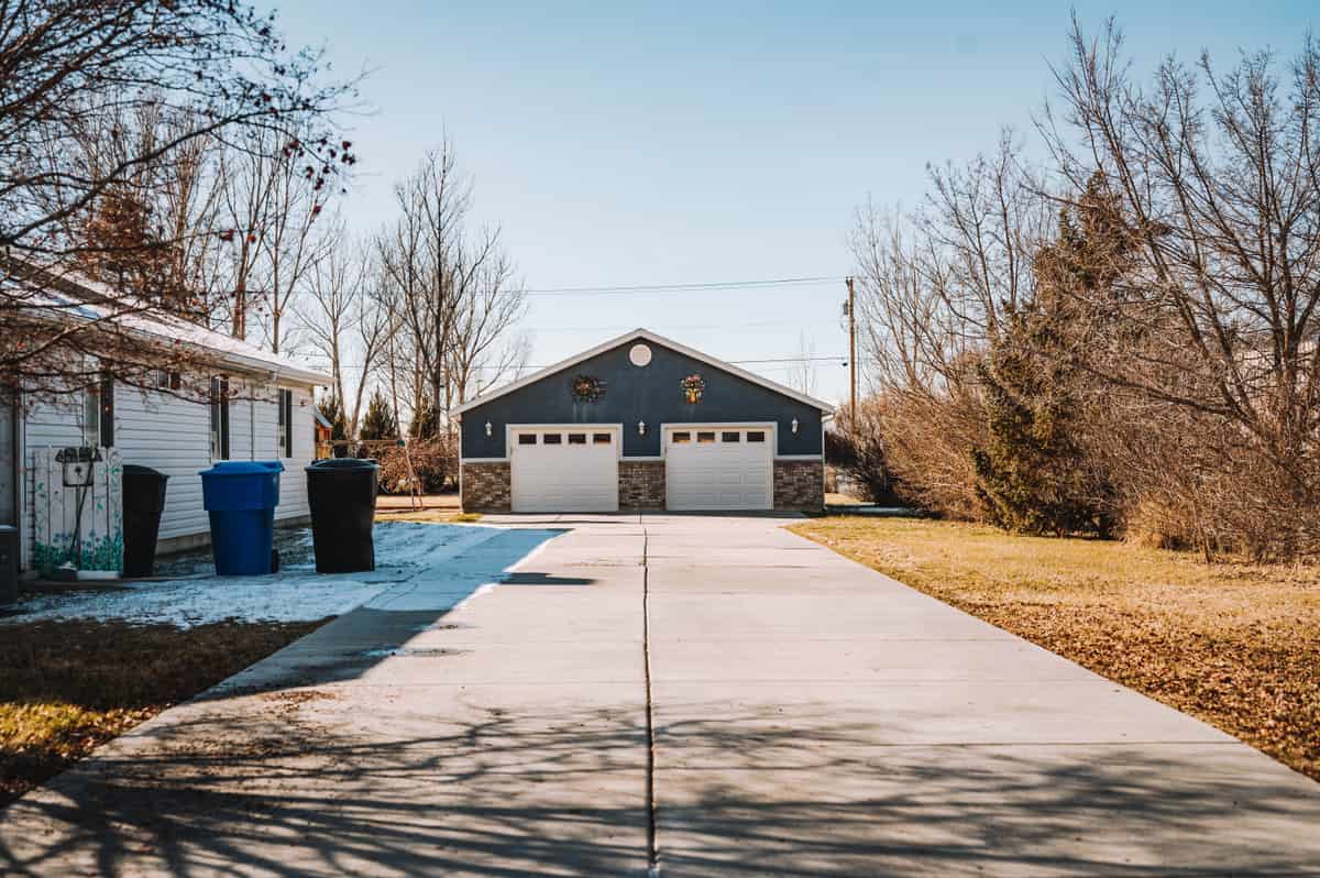 A detached residential garage beside a house