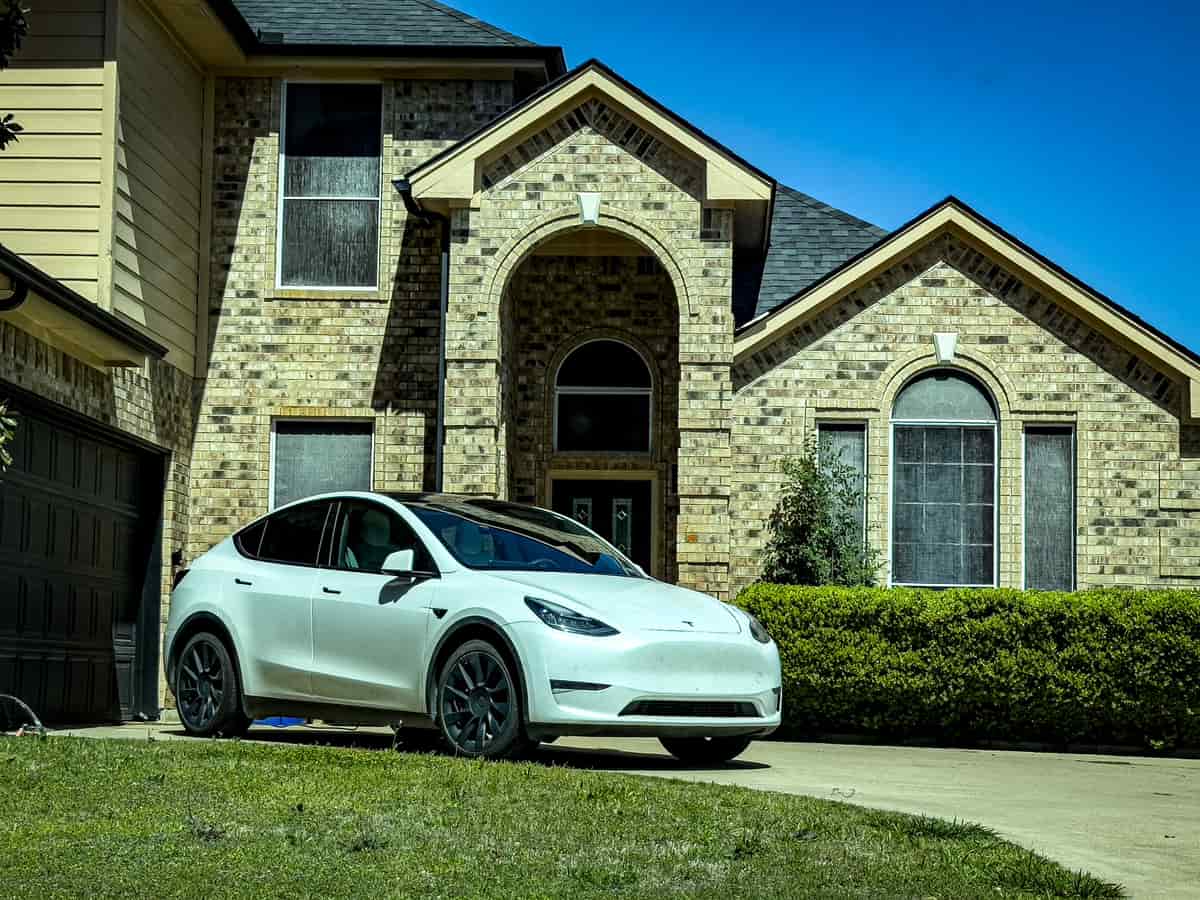 A car parked at a home in the evening