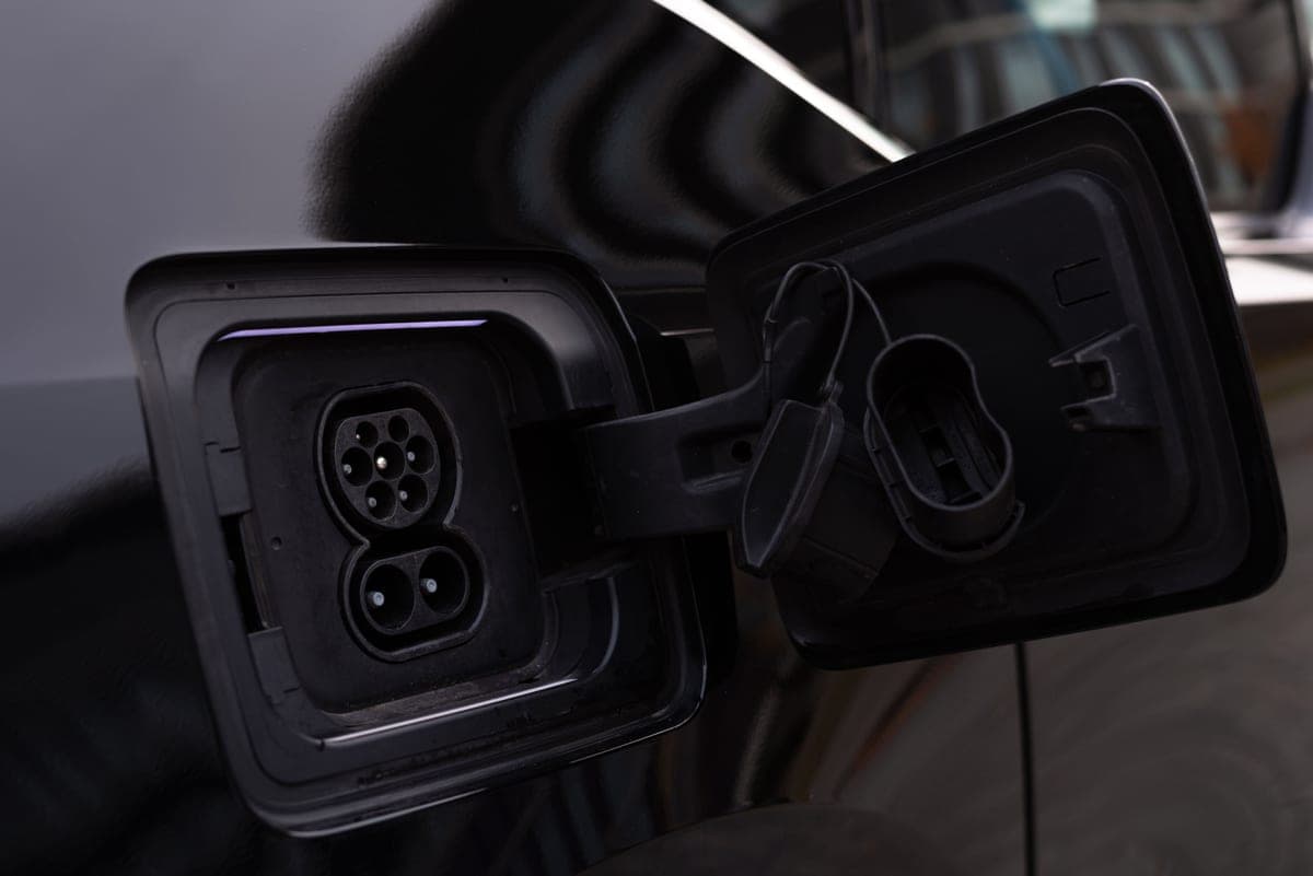 A close-up of an electric vehicle charging port and connector