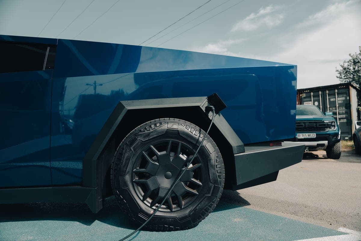 An electric pickup truck parked and charging