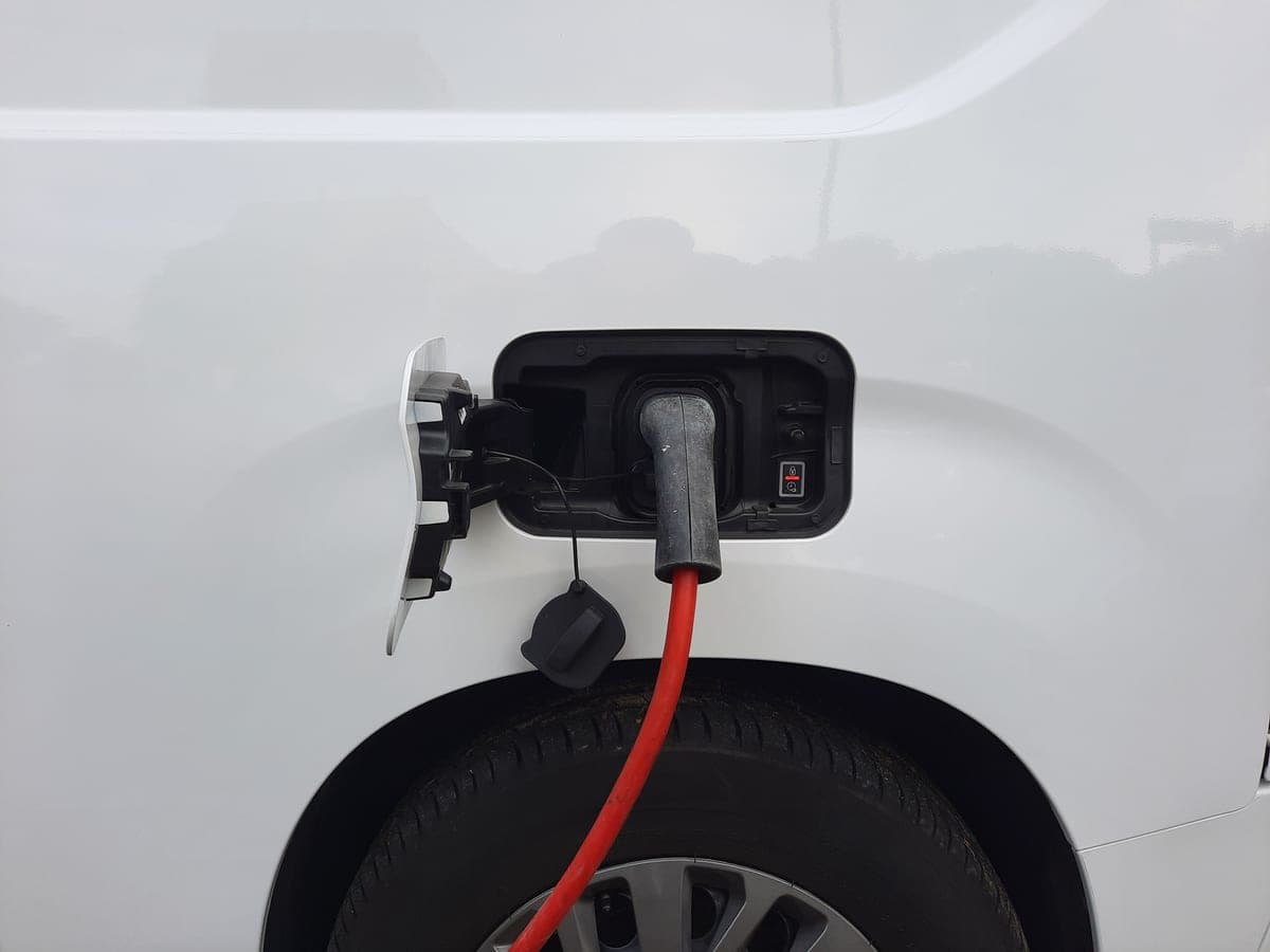 An EV charging cable plugged into a wall outlet