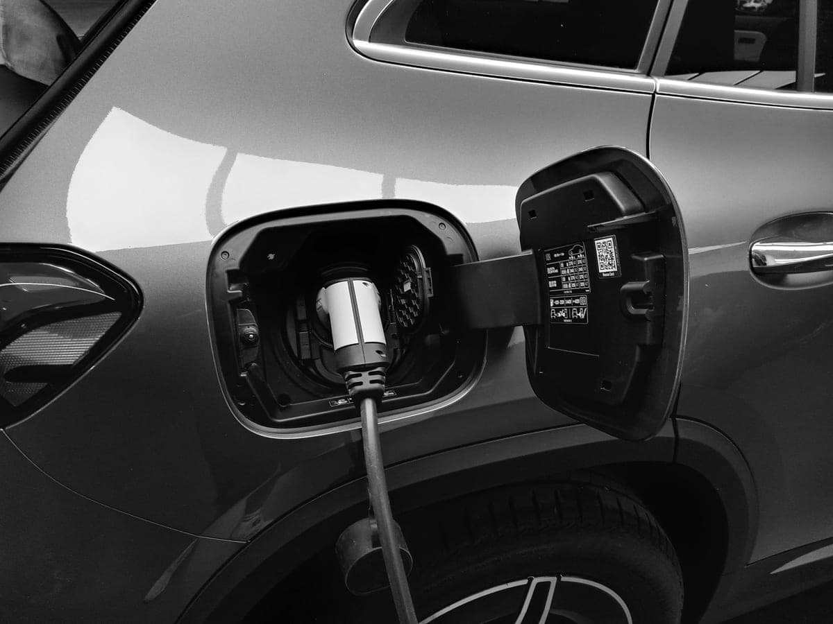 A charging connector plugged into an electric car's charge port