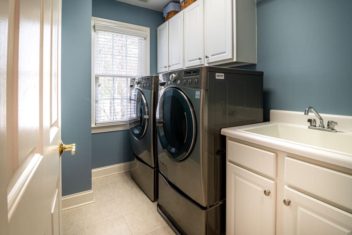 A home laundry room with a front-loading washer and dryer